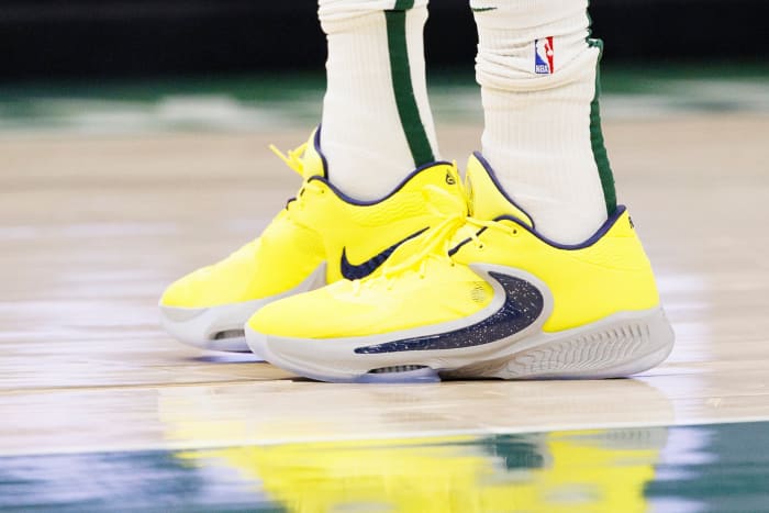 View of yellow and black Nike Zoom Freak shoes.